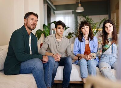 Family of Four on a Couch In A Counselling Session